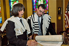 A Bar Mitzvah boy reading from an Ashkenazi-style Torah Scroll.